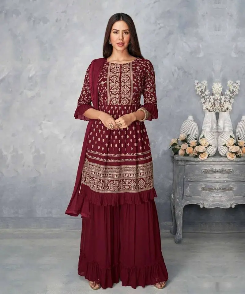 women adorned wine color sharara set